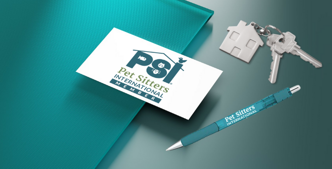 Why Use a Pet Sitters International member Pet Sitters International member business card is on table with a teal folder, house keys and pen